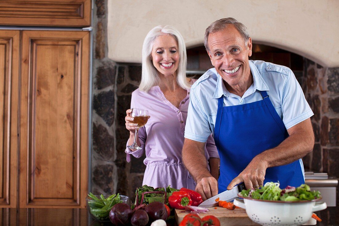 An older couple cooking together in the kitchen