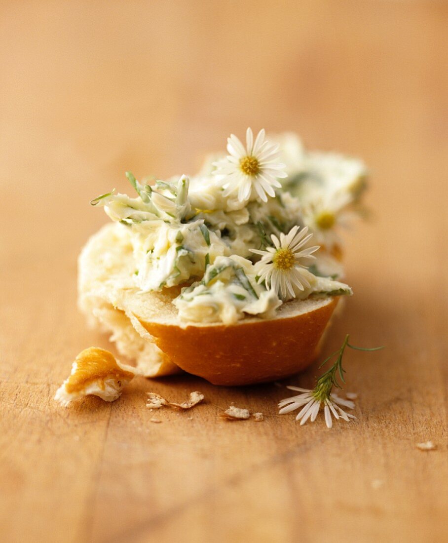 A slice of white bread with daisy butter