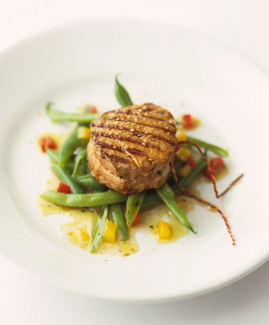 Grilled medallion of beef on green beans