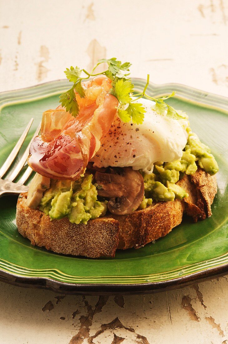 Brot mit Avocado, Pilzen, Bacon und pochiertem Ei