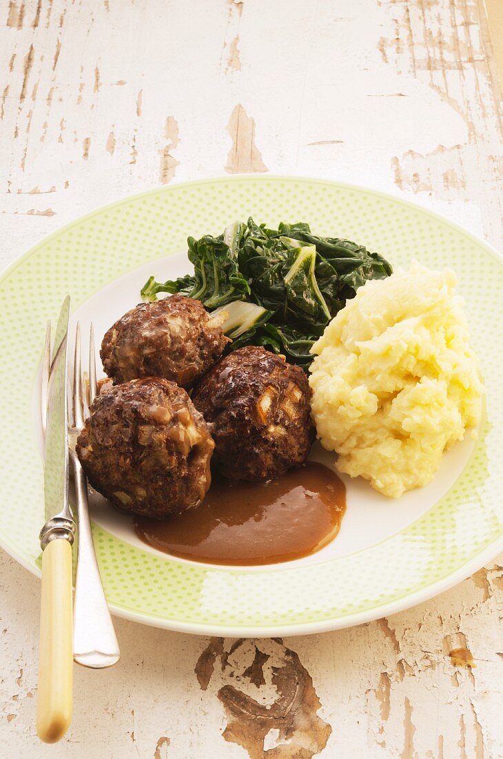 Meatballs with mashed potato, chard and gravy