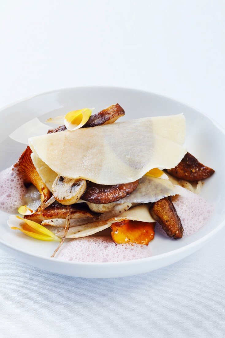 An open lasagne with dahlia foam and fried mushrooms