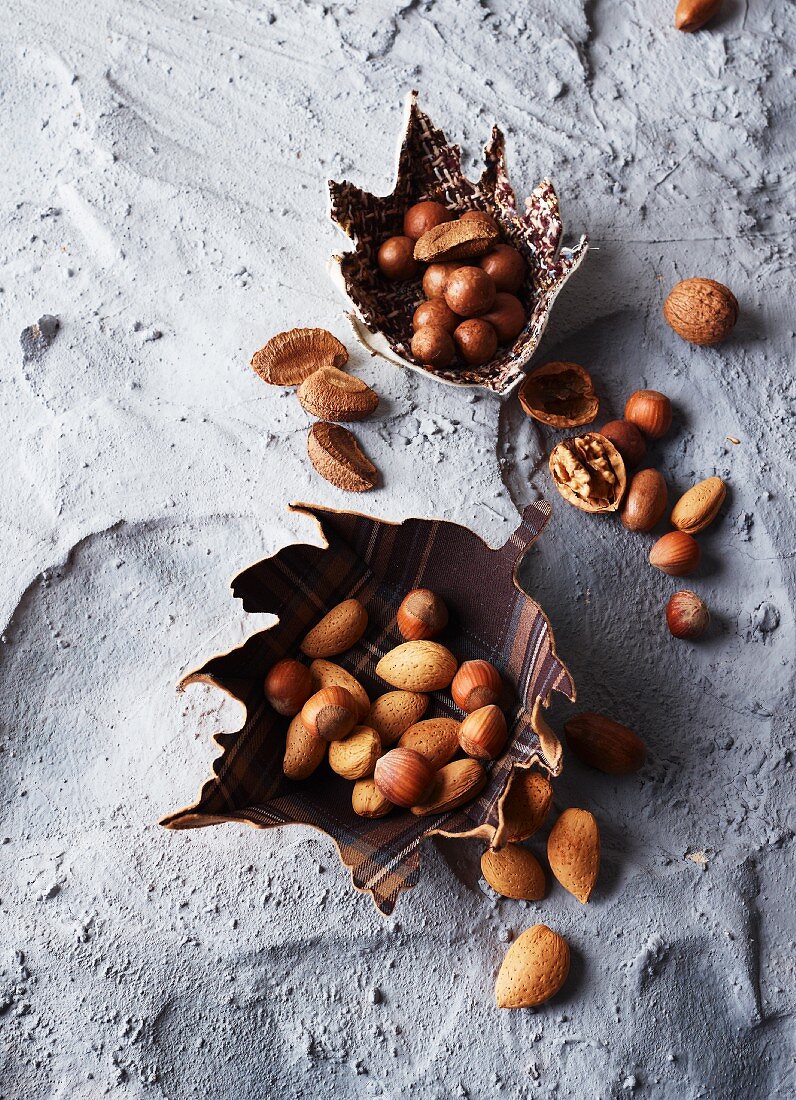 Assorted nuts in leaf-shaped bowls