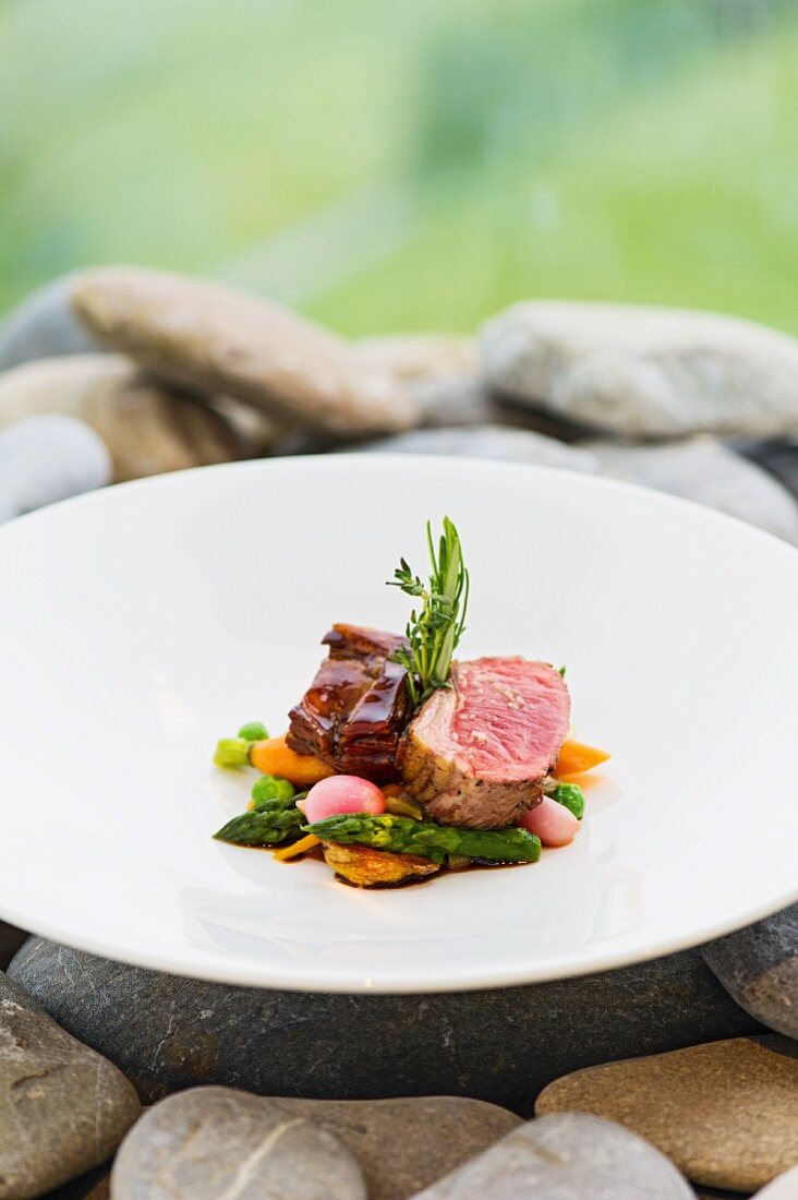 Medallion of lamb and glazed breast of lamb with spring vegetables