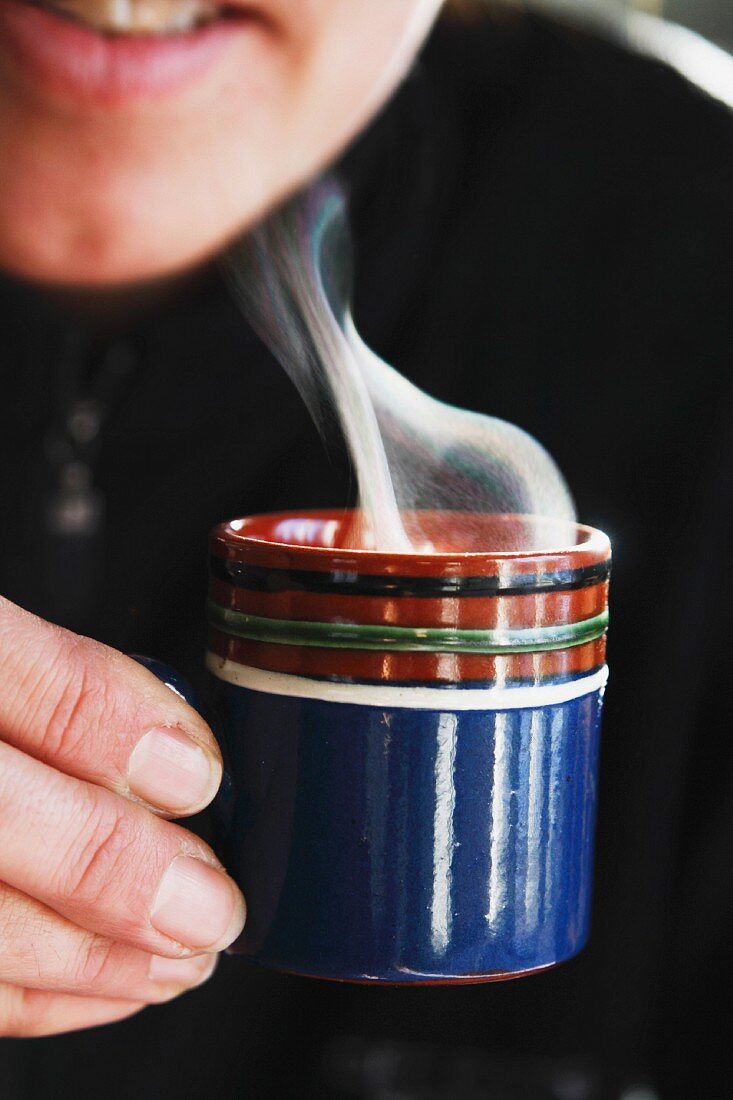 Woman drinking hot espresso