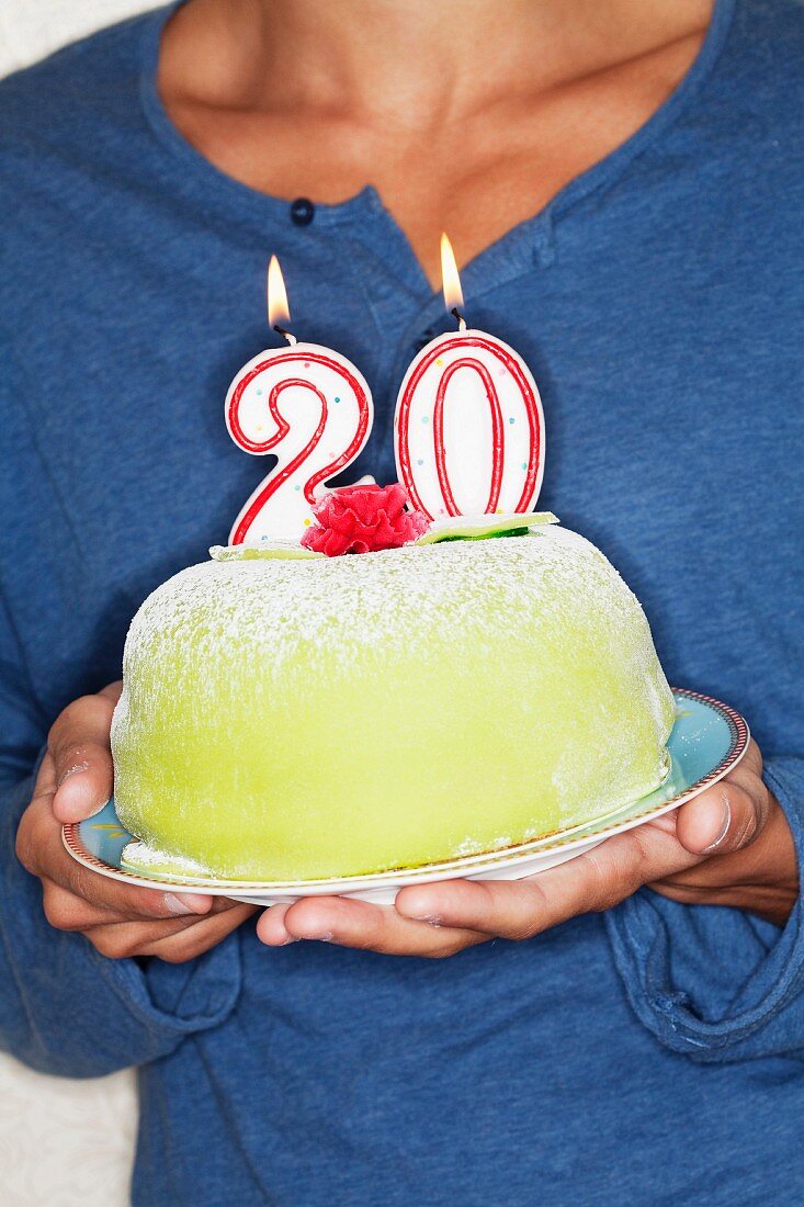 Young man holding birthday cake