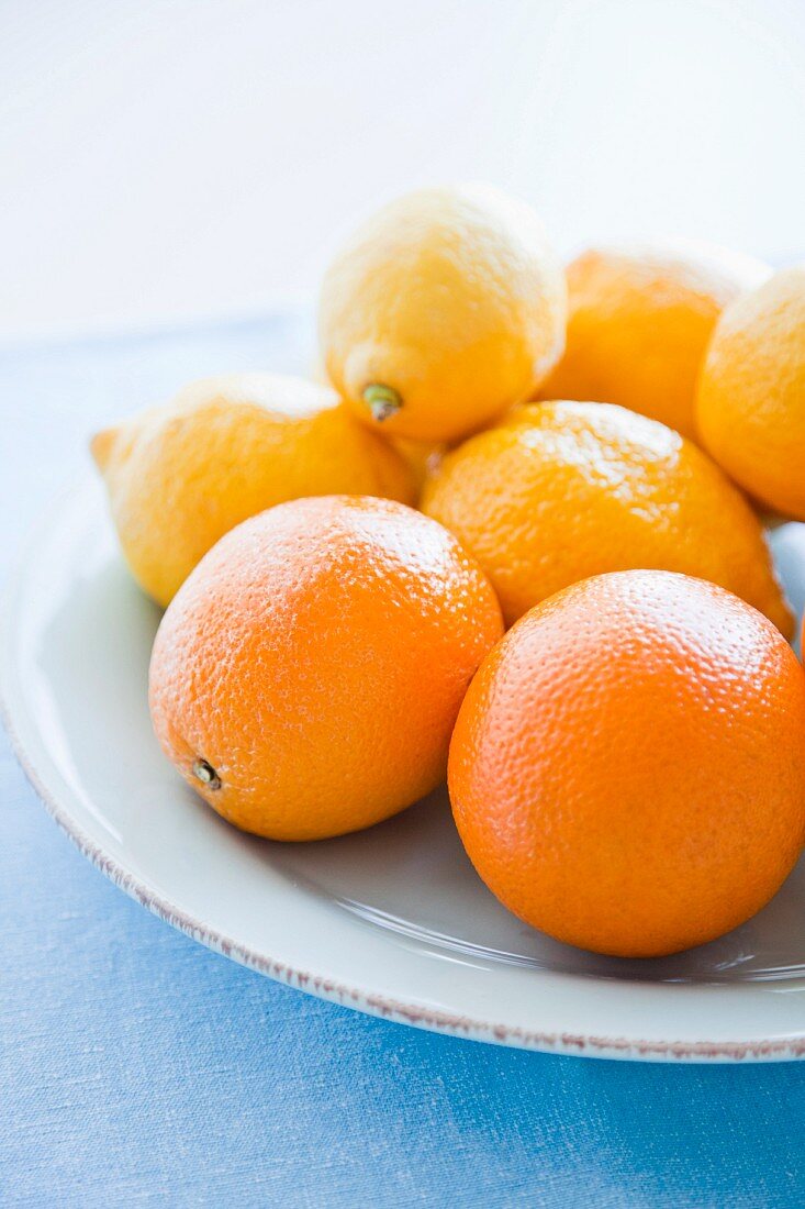 Oranges and lemons on plate