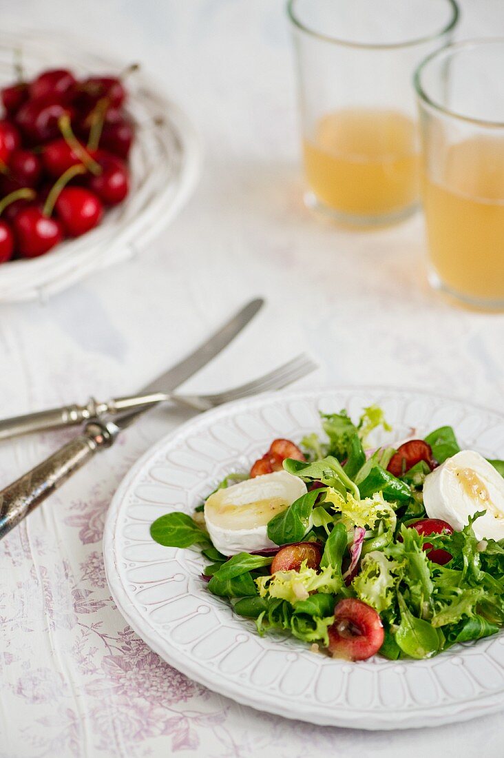 A salad with a cherry vinaigrette and goat's cheese