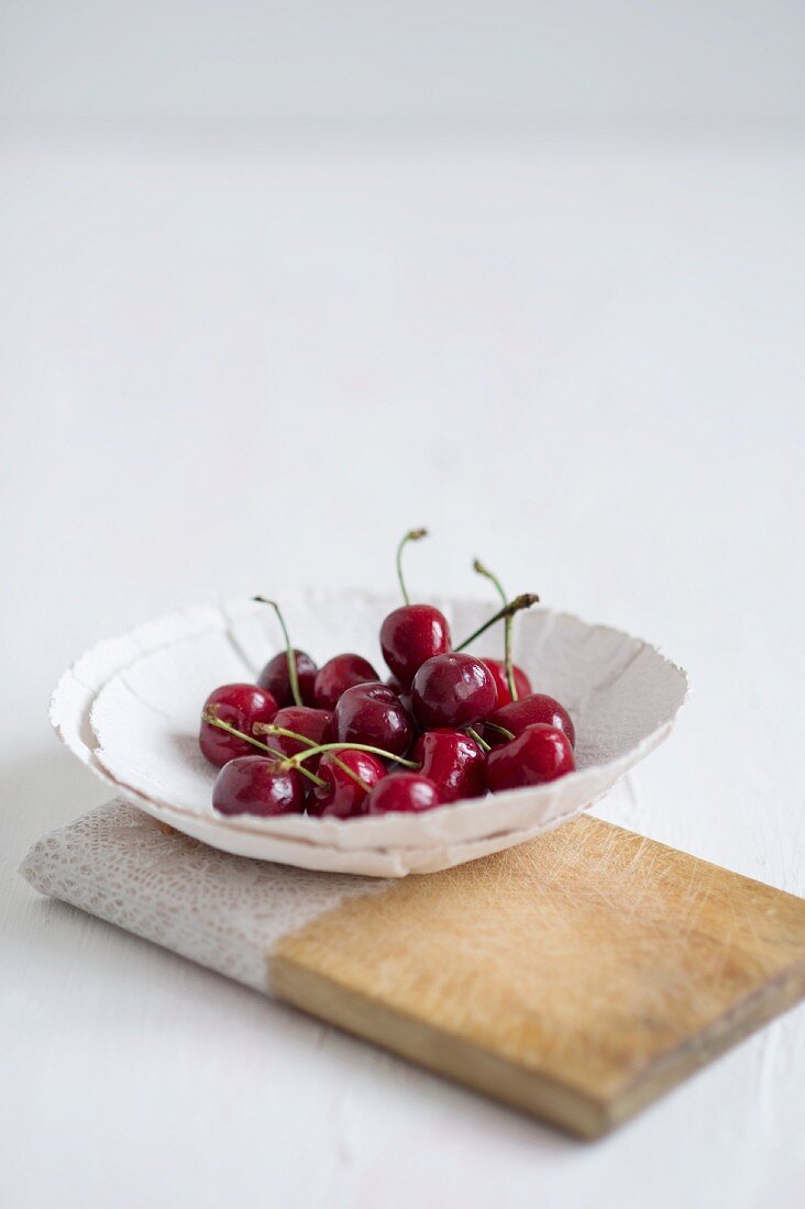 Cherries in a white porcelain bowl