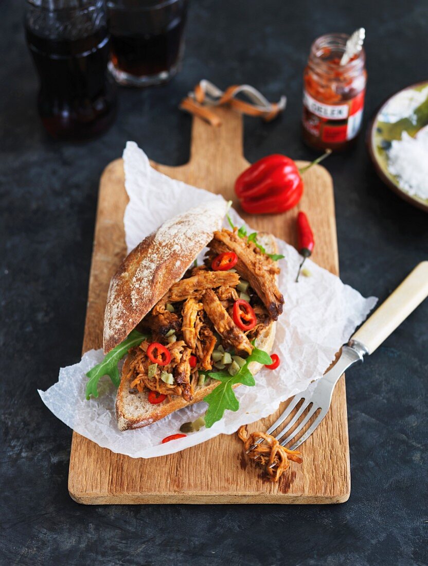 Pulled pork burger with sliced chillies and rocket