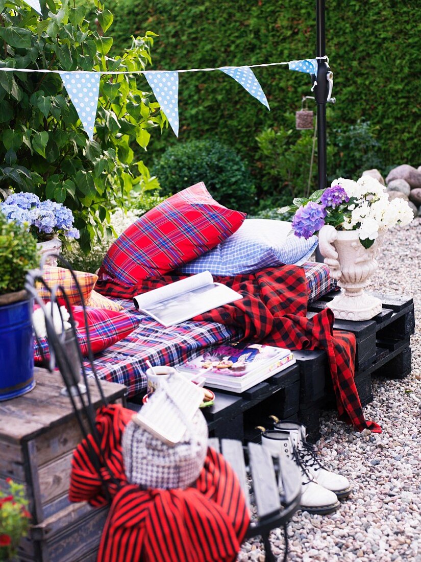 Furniture with textiles in a garden, Sweden.