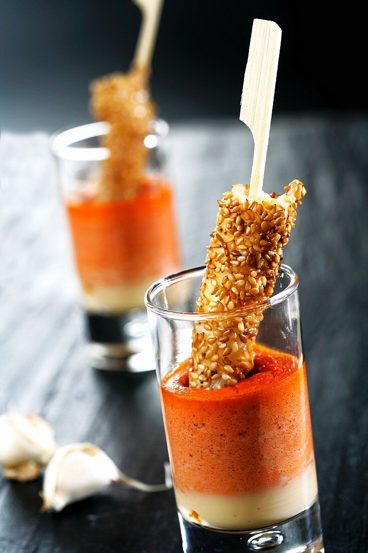 Tomato and pepper dip with prawn and sesame skewers