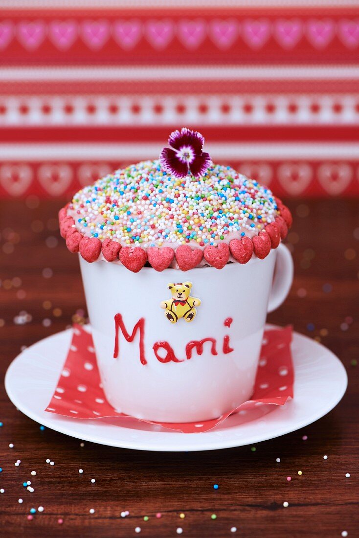 Cupcake for Mother's Day in a coffee cup with red hearts and a teddy bear