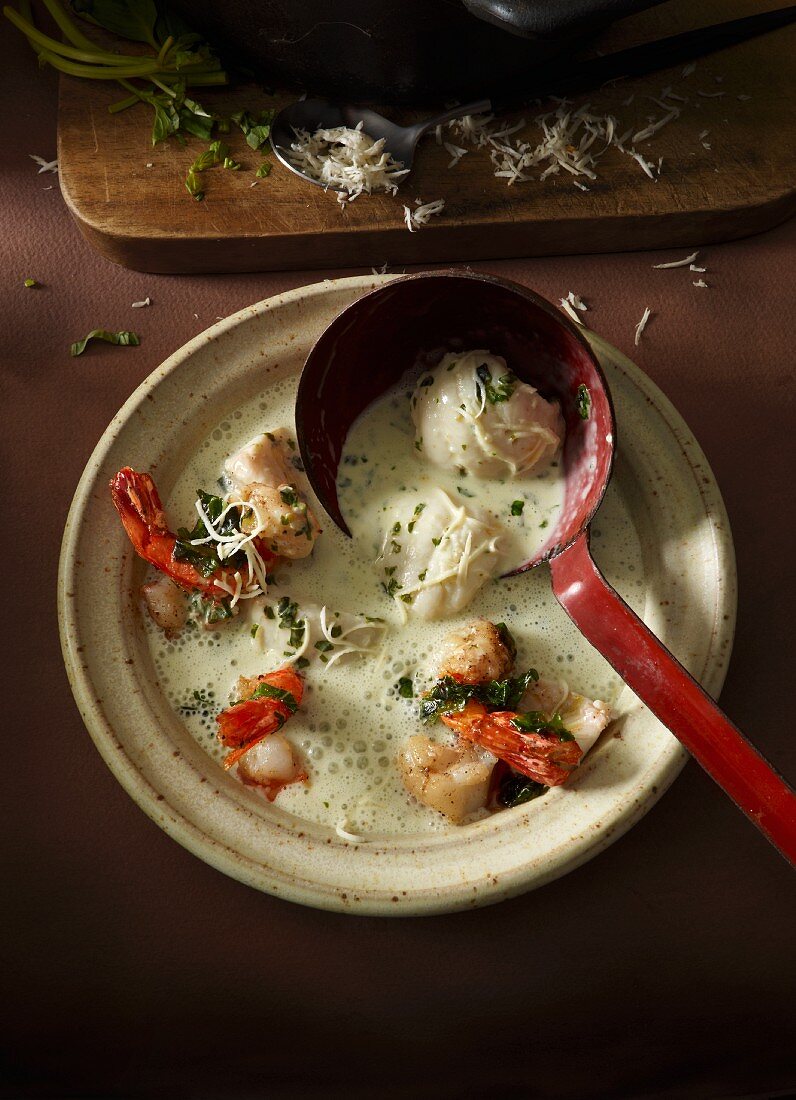 Cream of horseradish soup with zander and prawns