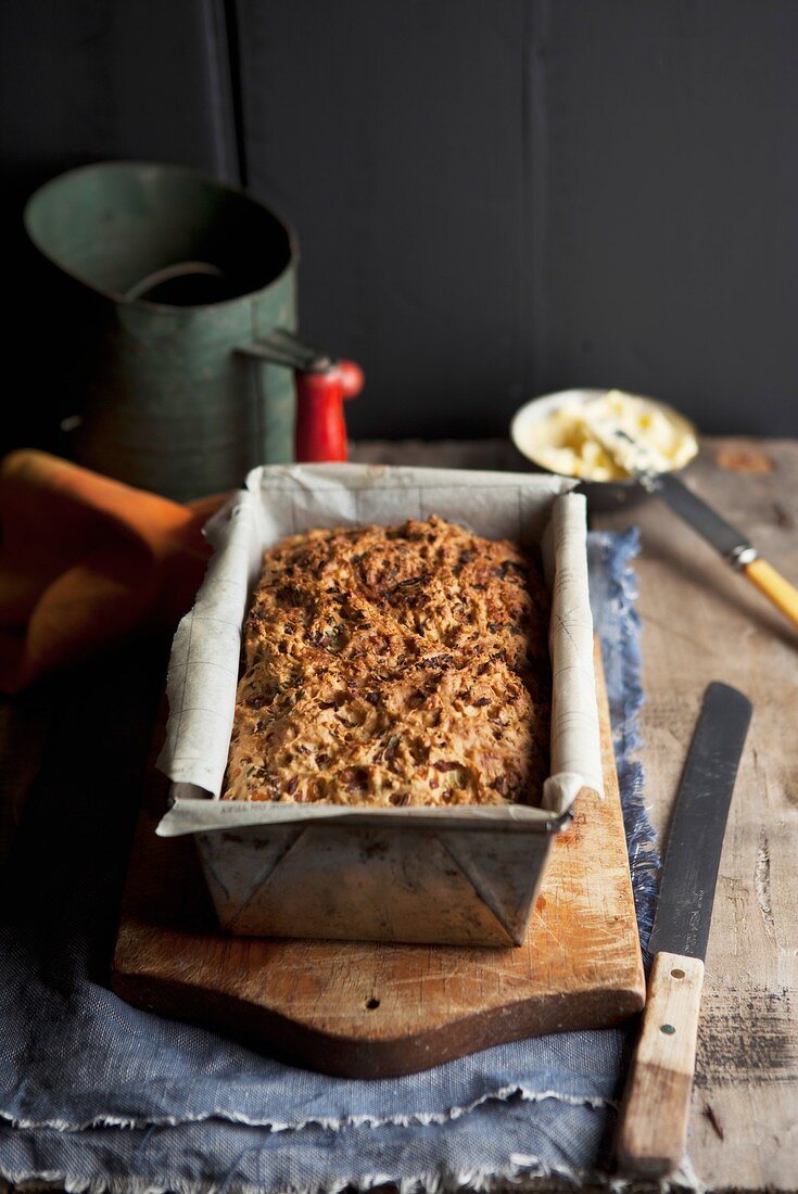 Baked onion bread with cheese and herbs, in a loaf tin