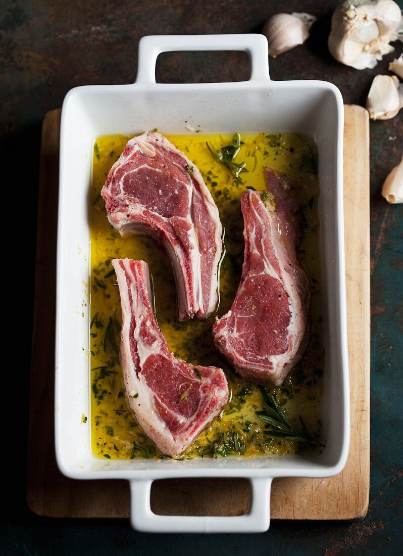 Raw lamb chops in marinade (view from above)