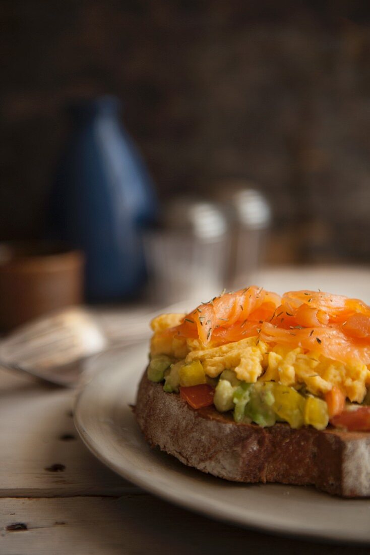 Toast with guacamole, scrambled egg and smoked salmon