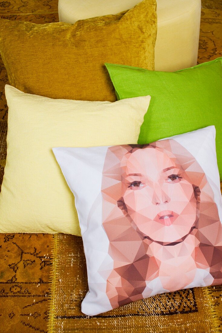 Scatter cushions in yellow, green and gold and one with print portrait (Kate Moss)