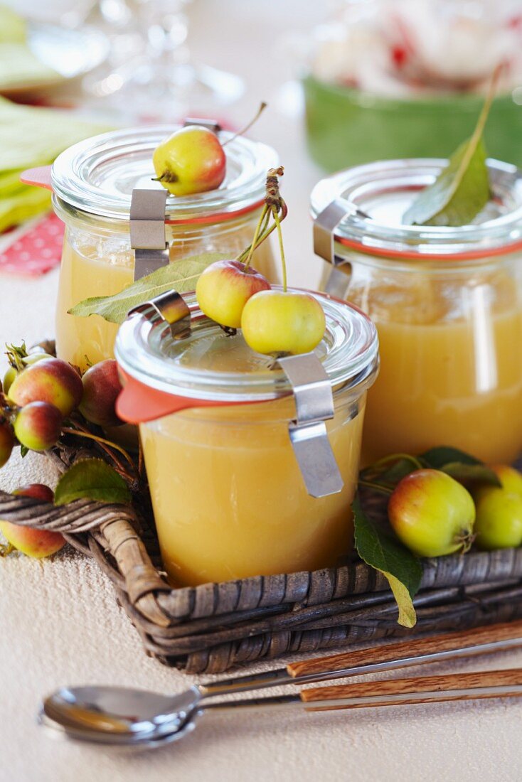 Apple sauce in small jars decorated with ornamental apples