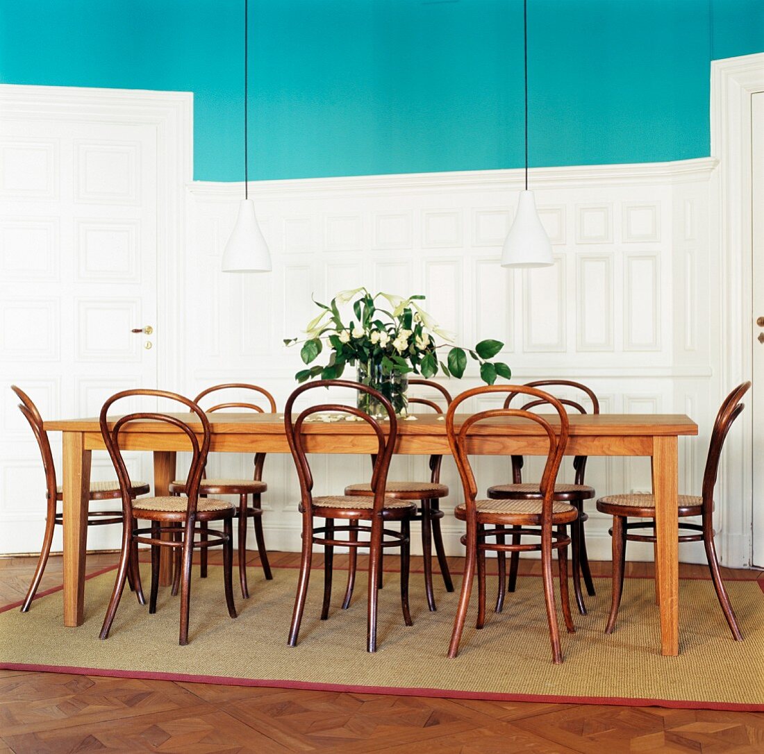 Lights hanging above dinning table and chairs