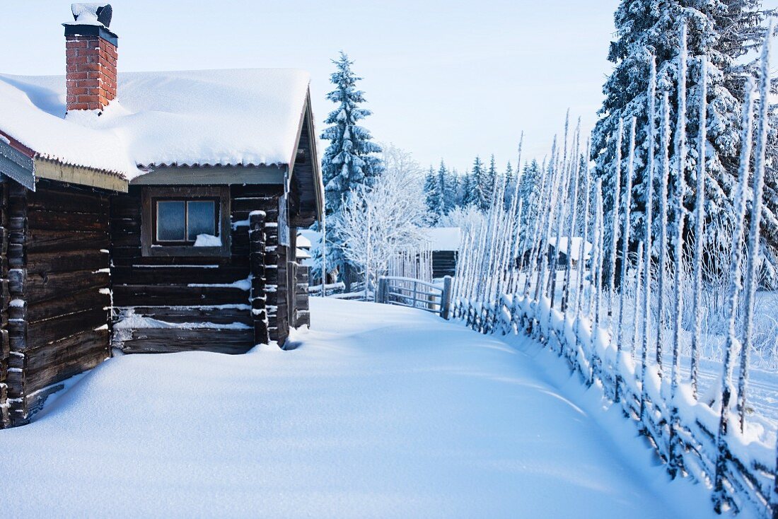 Scandinavian log cabin in snowy winter landscape