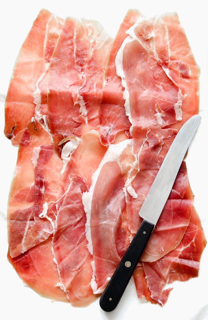 Several slices of Prosciutto from Sardinia, and a knife
