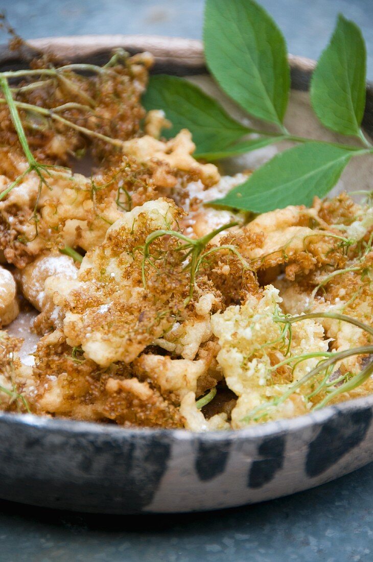 Deep-fried elderflowers in a bowl