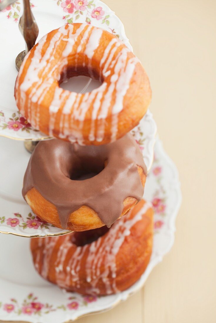 Doughnuts with glacé icing and with chocolate glaze, on a tiered cake stand