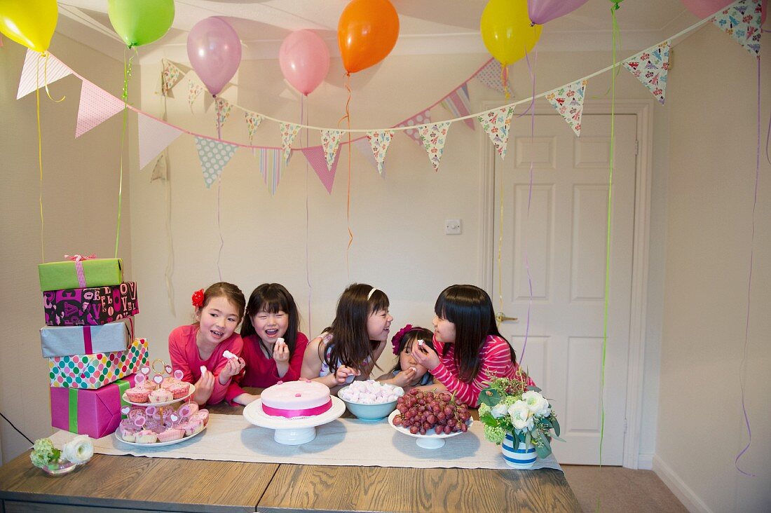Girls sharing birthday cake at party