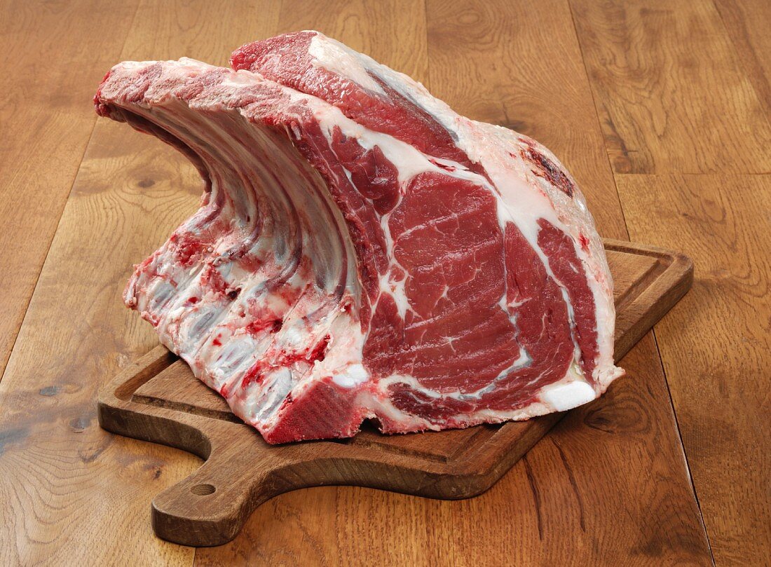 Rack of beef ribs on a chopping board