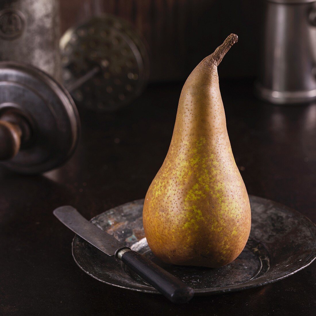 Raw pear on rustic background.