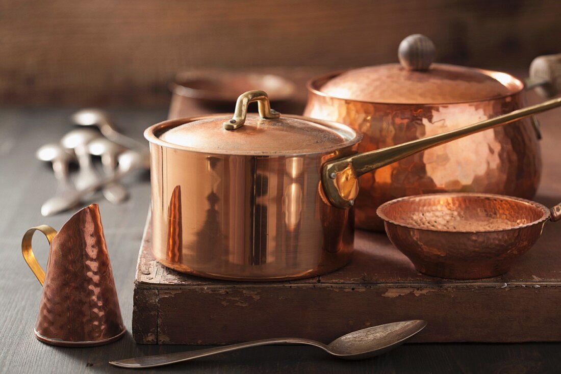 Assorted copper pots and cooking utensils