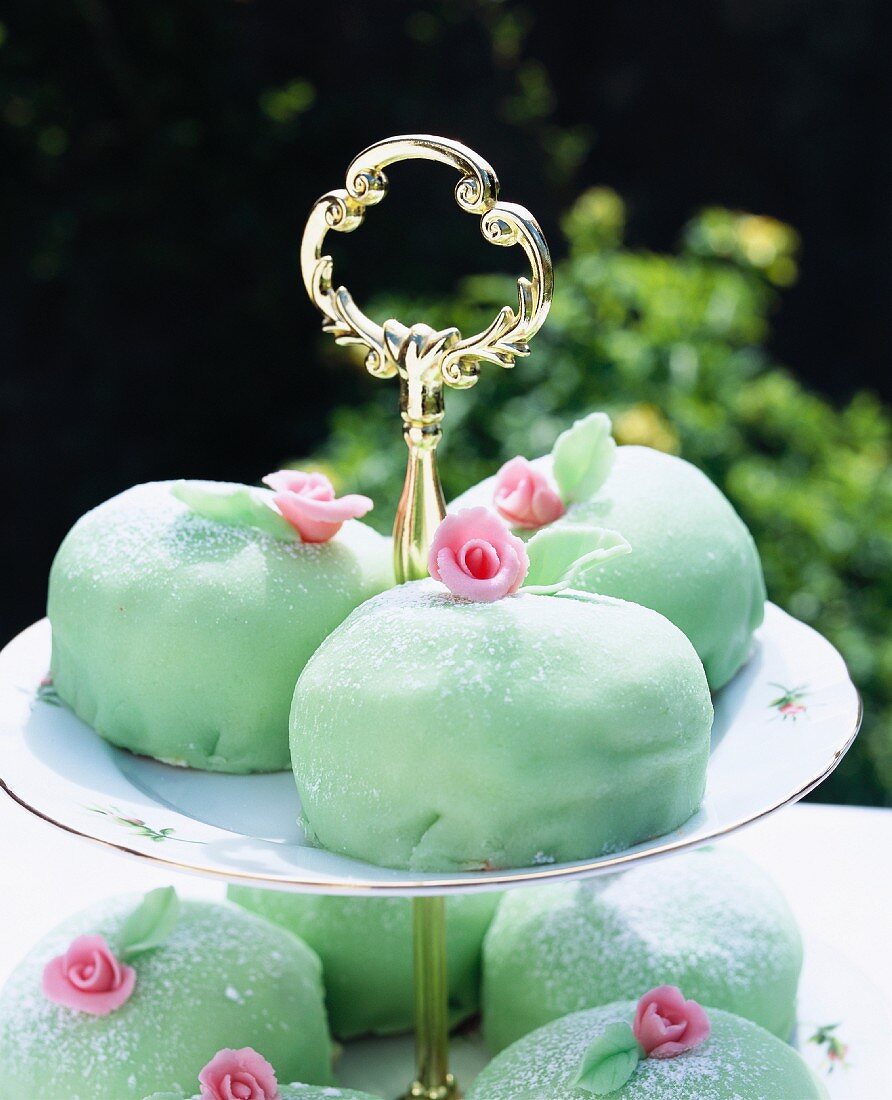 Mint-coloured marzipan cakes on a tiered cake stand