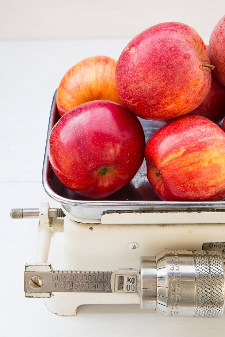 Apples (Royal Gala) on a set of old kitchen scales