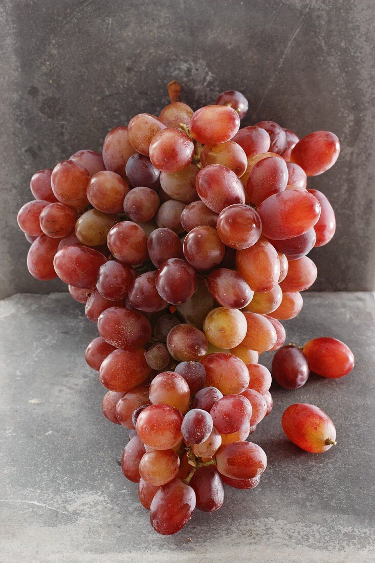 Pink grapes with a stone background