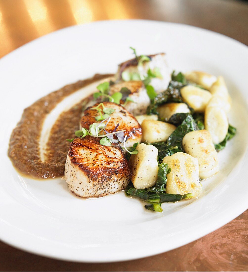 Seared scallops with greens and dumplings
