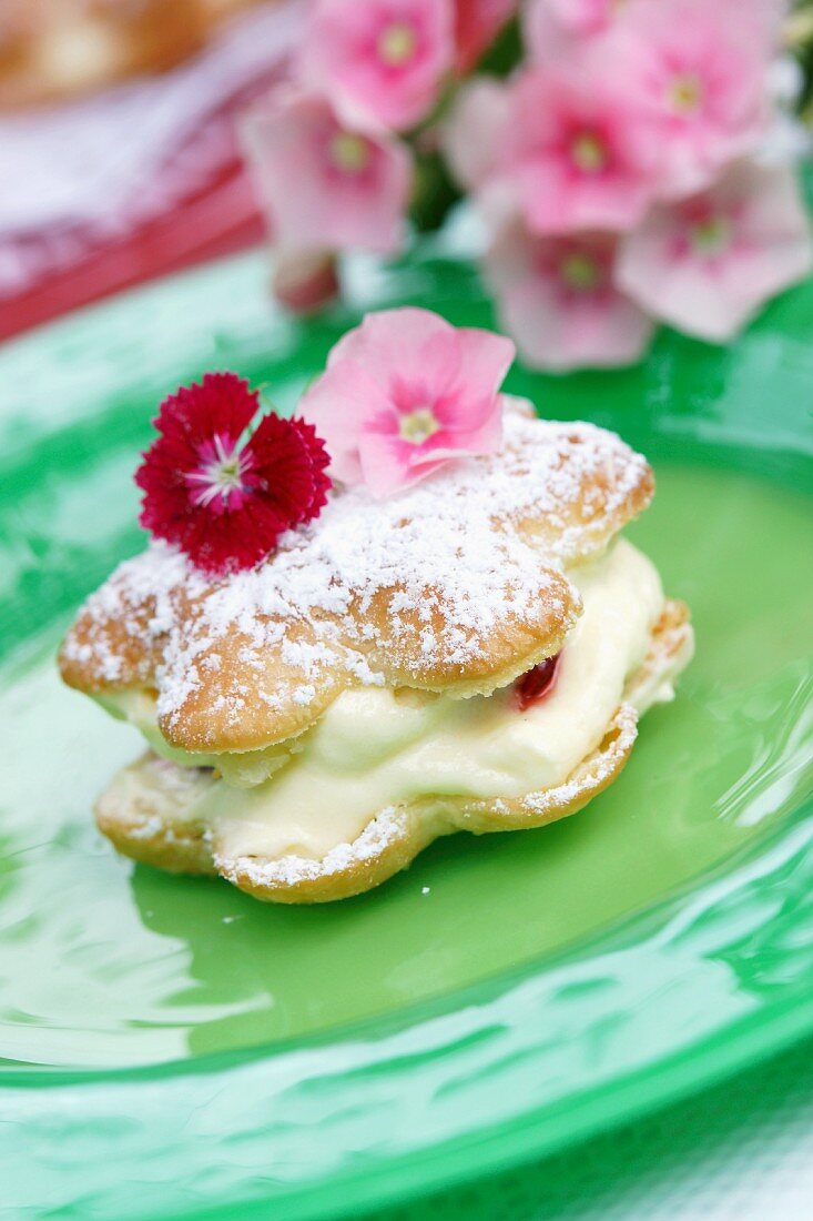 Choux pastry filled with crème pâtissière and topped with edible flowers