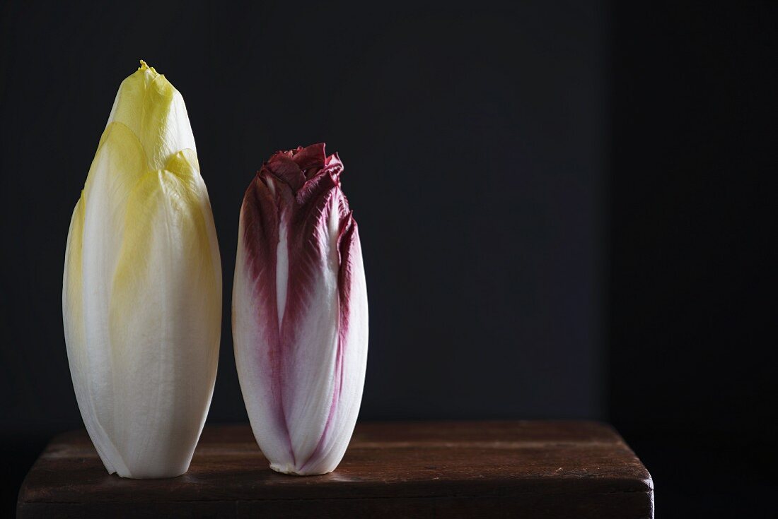 Chicory and red endive on a wooden table