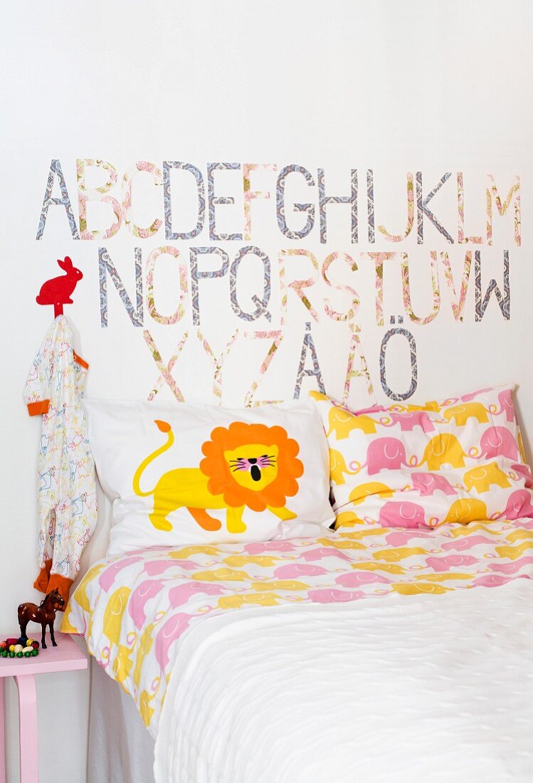 Nursery room with bed and alphabets on wall