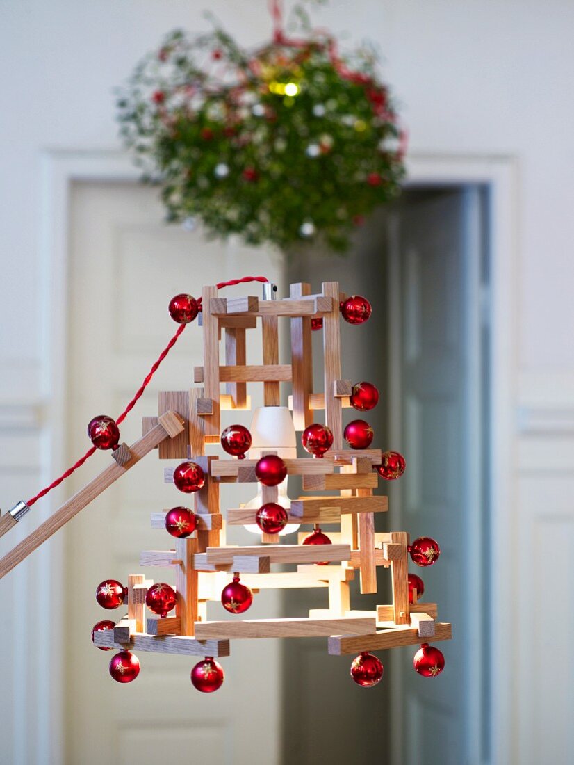Festively decorated lamp made from wooden rods