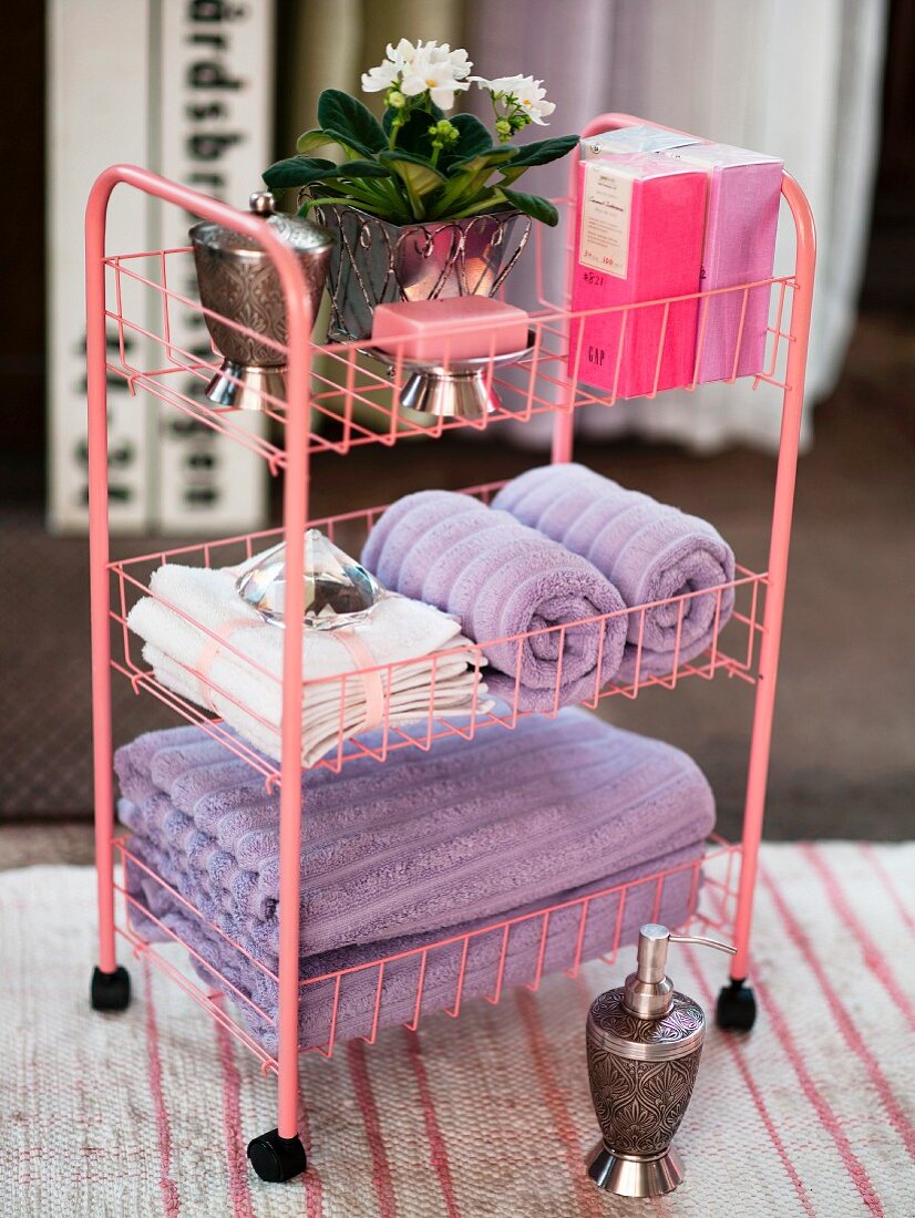 Pink bathroom trolley for storing towels and toiletries