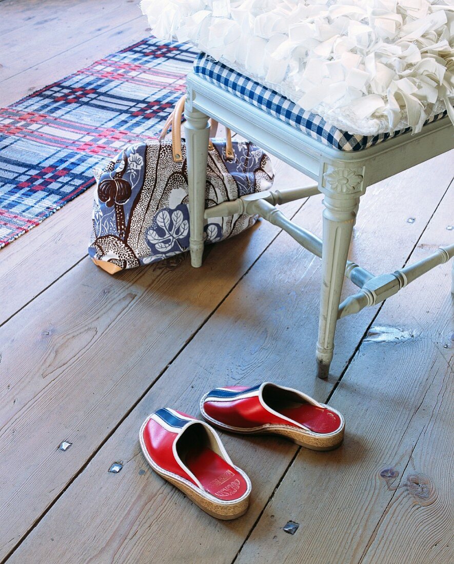 Handbag & slippers next to chair in hallway