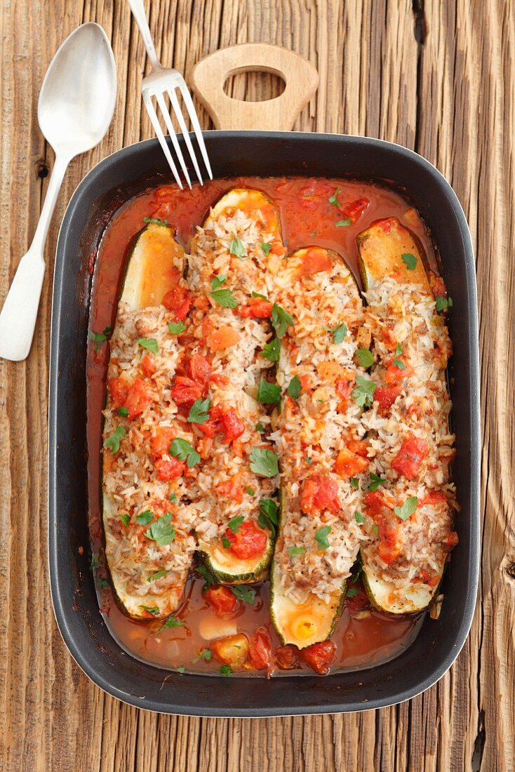 Courgettes stuffed with minced pork and rice, in tomato sauce