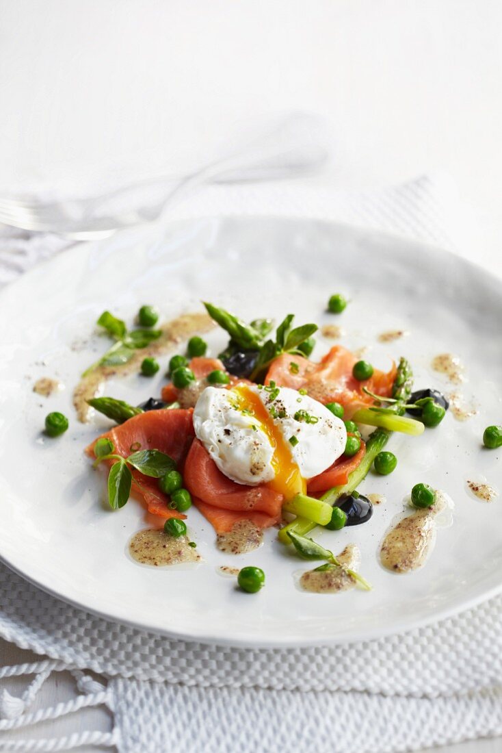 Poached egg on smoked trout with asparagus, peas and a mustard dressing