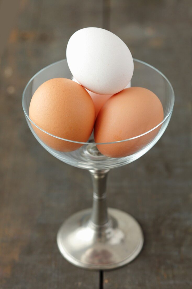 Four eggs in a glass with a stem