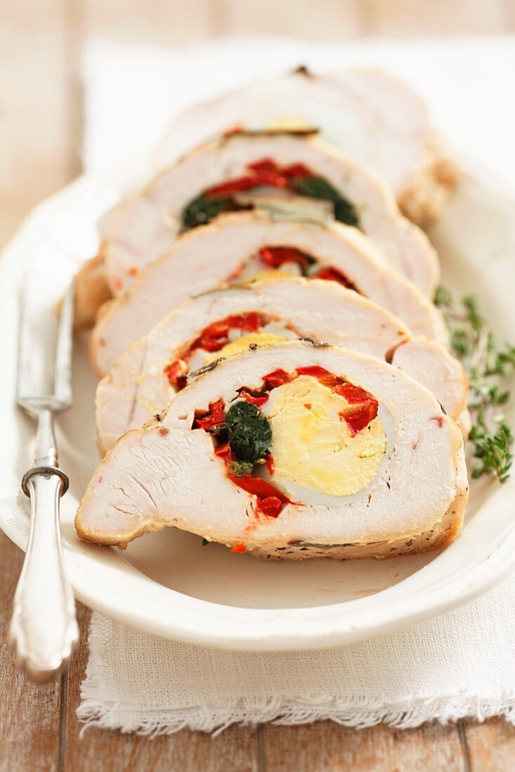 Turkey breast stuffed with egg, spinach and red peppers