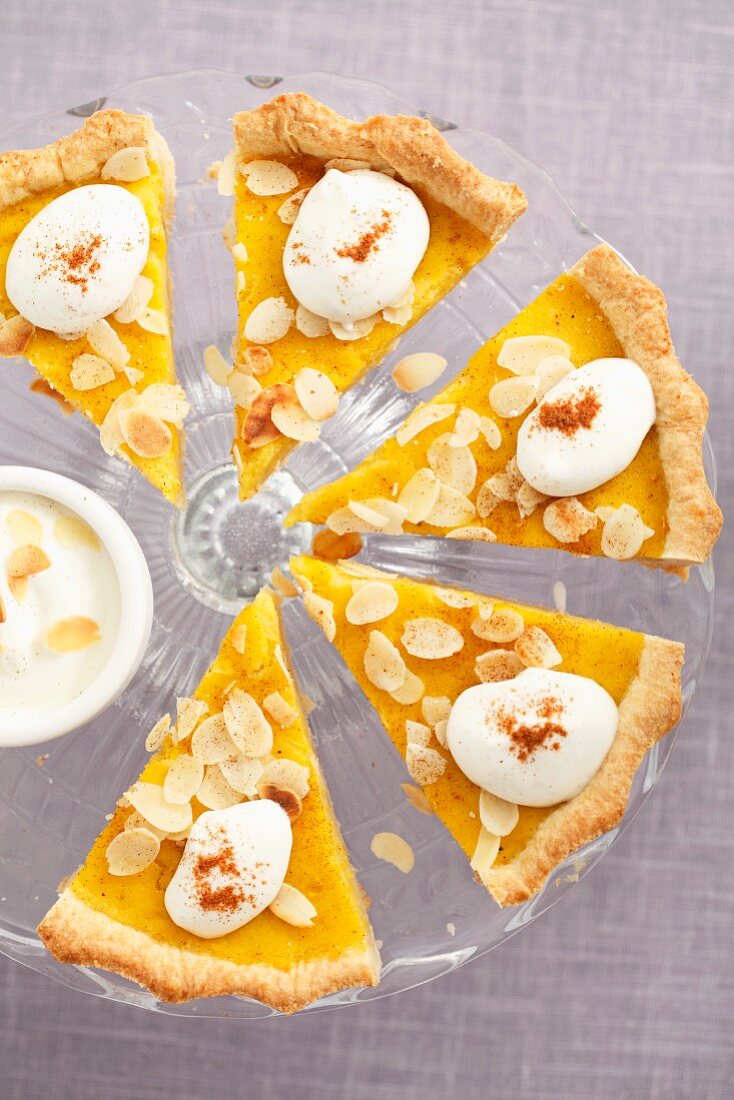 Pumpkin tart with flaked almonds, cut into slices