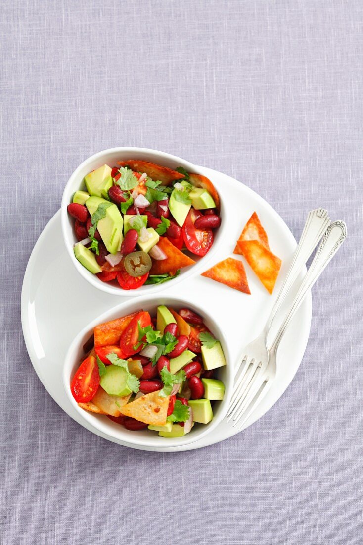 Tomato and avocado salad with kidney beans and tortilla chips