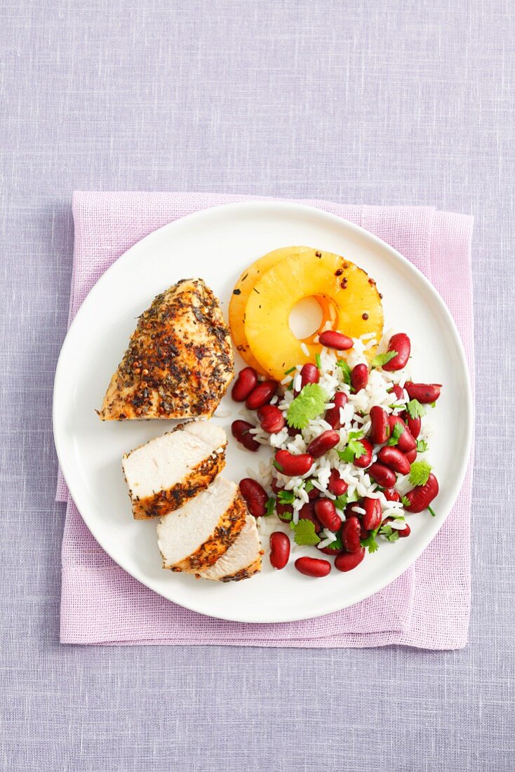 Chicken breast with rice, kidney beans, coriander leaves and grilled pineappe