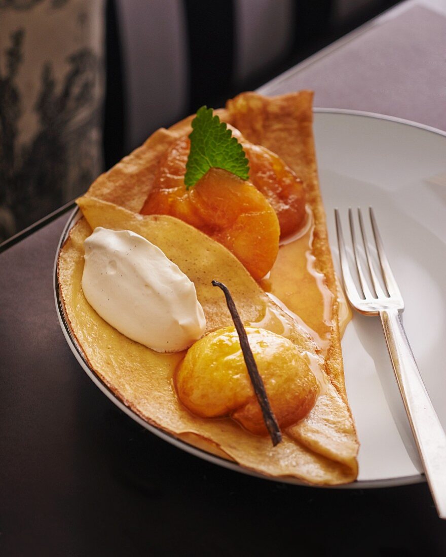 Pancake topped with caramelised apples and vanilla ice cream